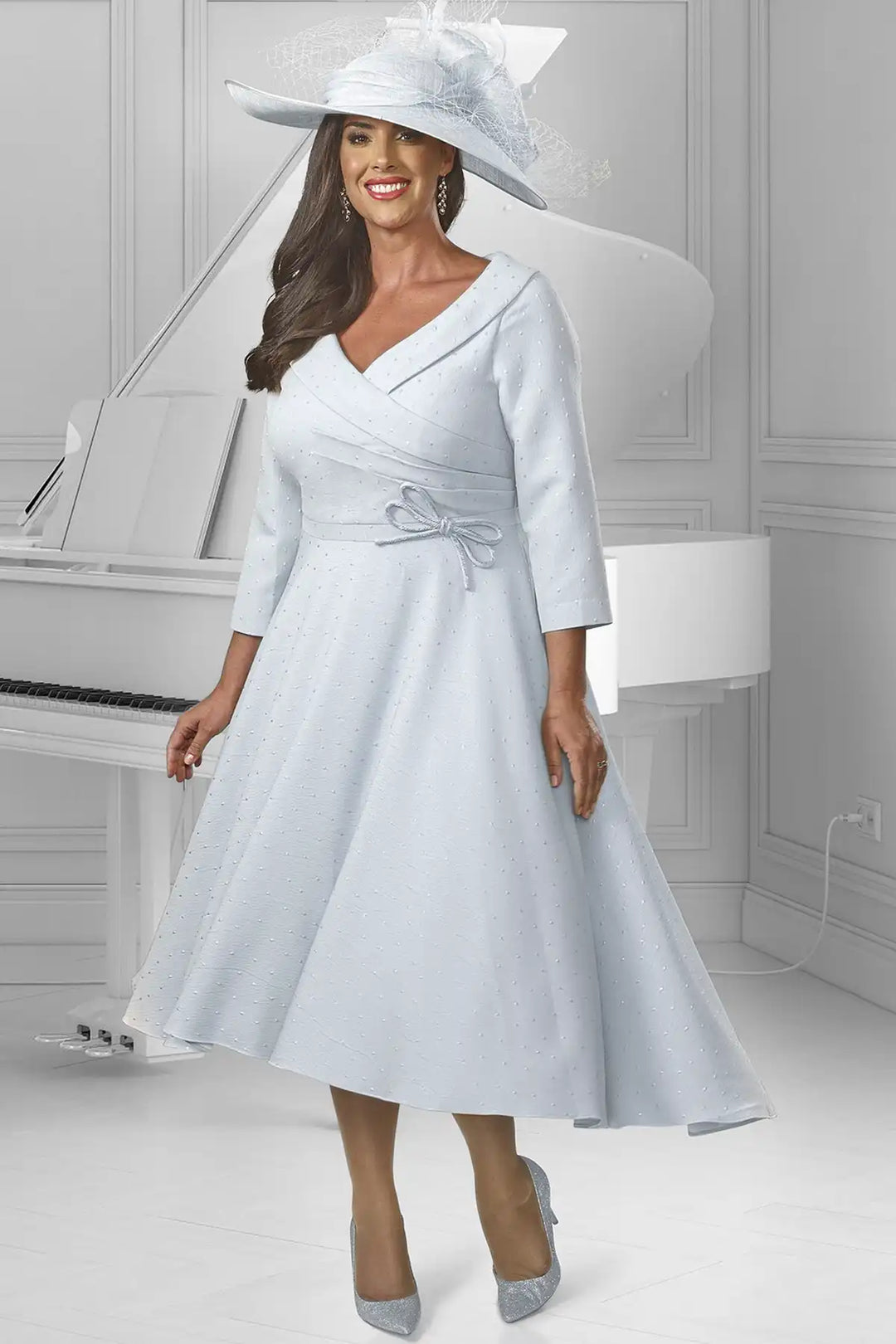 Elegant woman in a Dressed Up by Veromia DU569 V-neck, wrap bodice silver A-line dress with delicate shimmering details and a bow at the waist.
