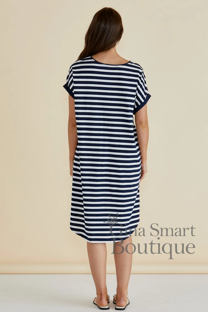 Betty Basics Maxine T-Shirt Dress rear view is a navy and white horizontal striped t-shirt dress with a high-low hem - available at Gina Smart Boutique