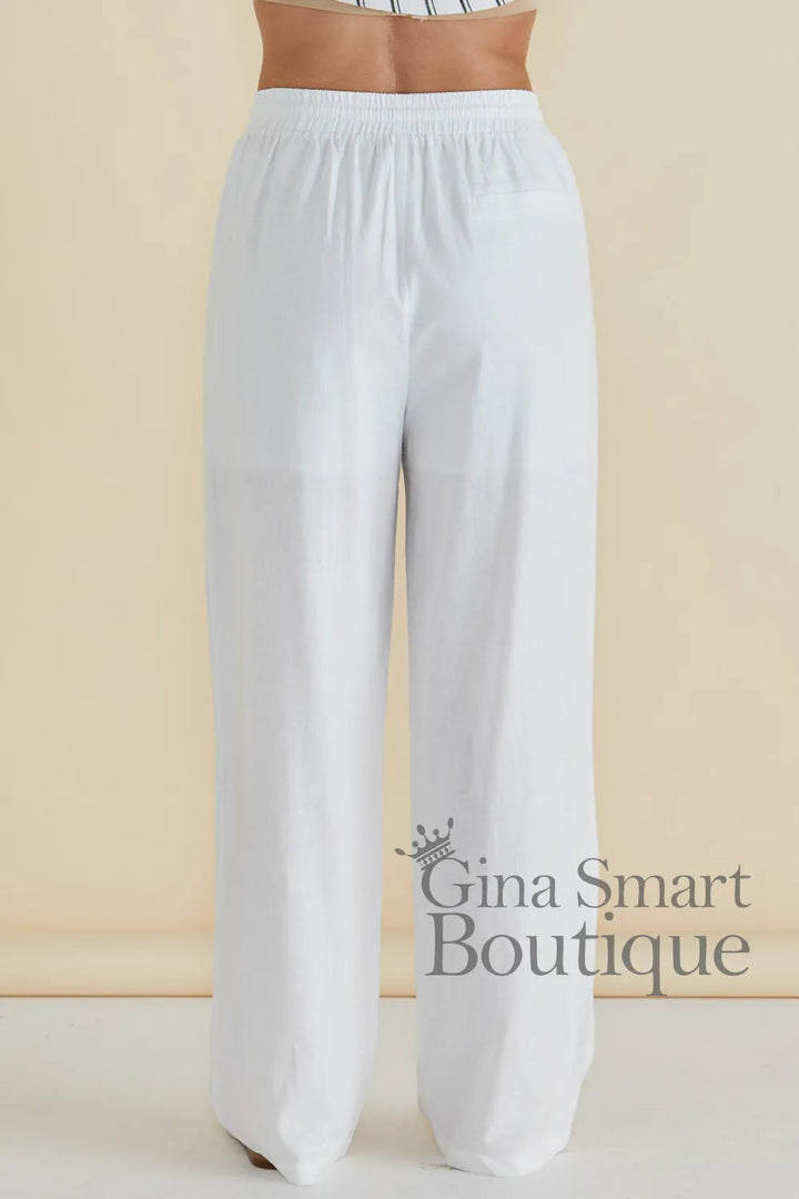 Betty Basics Zaza Relaxed Trouser back view is a white wide leg trouser with a comfortable elastic waistband.  Available at Gina Smart Boutique