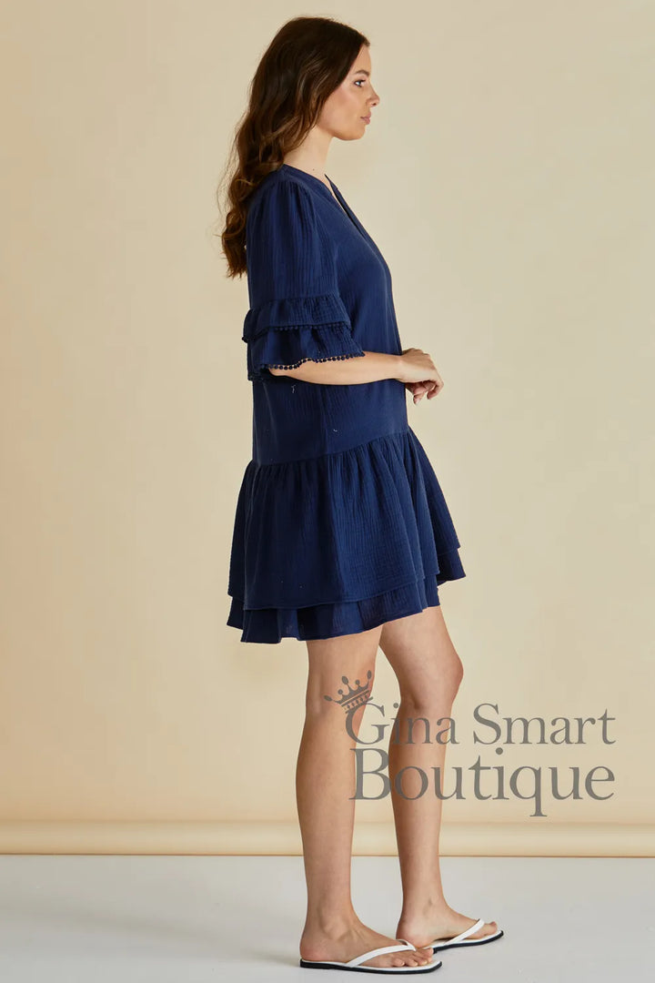 Betty Basics Malibu Dress side view navy mini dress featuring tiered ruffle sleeves and a drop waist flared skirt - available at Gina Smart Boutique
