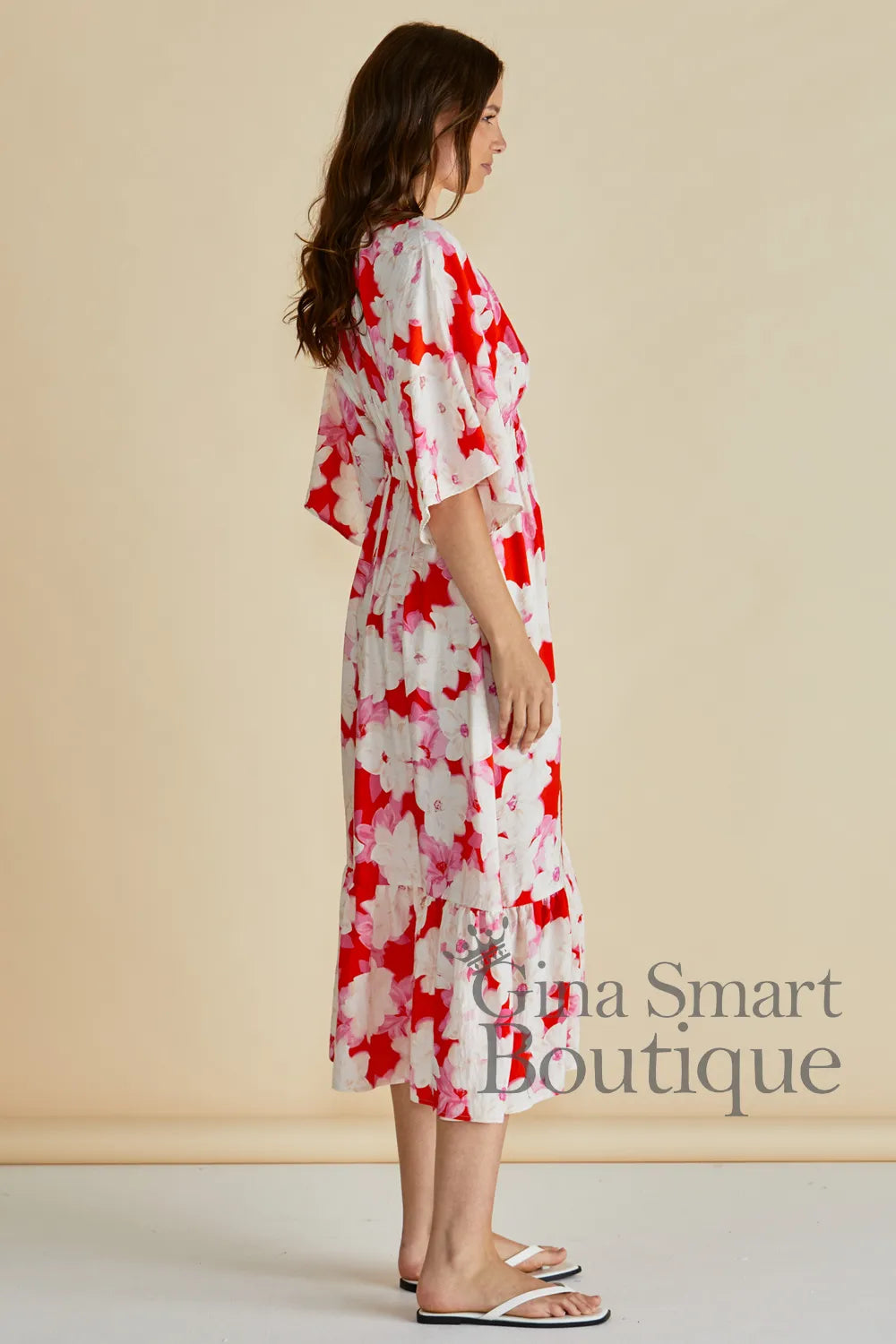 Betty Basics Moxie Dress side view red a pink abstract floral midi dress with flutter sleeves and smoked waist - available at Gina Smart Boutique
