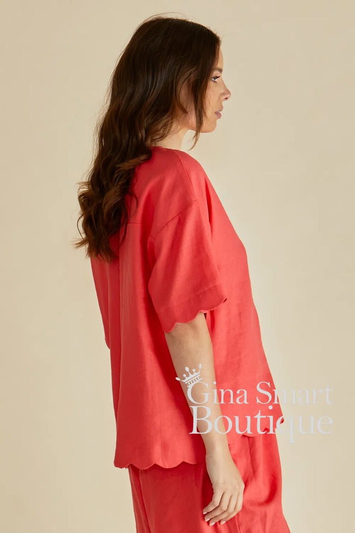 Betty Basics Scarlett Tangerine Shirt side view is a button down V-neck top with a scalloped hem.  Available from Gina Smart Boutique.