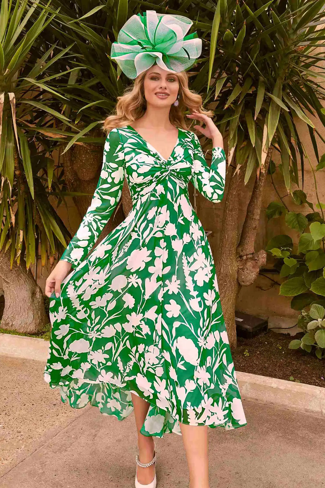 Chic woman in Invitations by Veni 36007 dress with bold shamrock green and ivory floral pattern, V-neckline