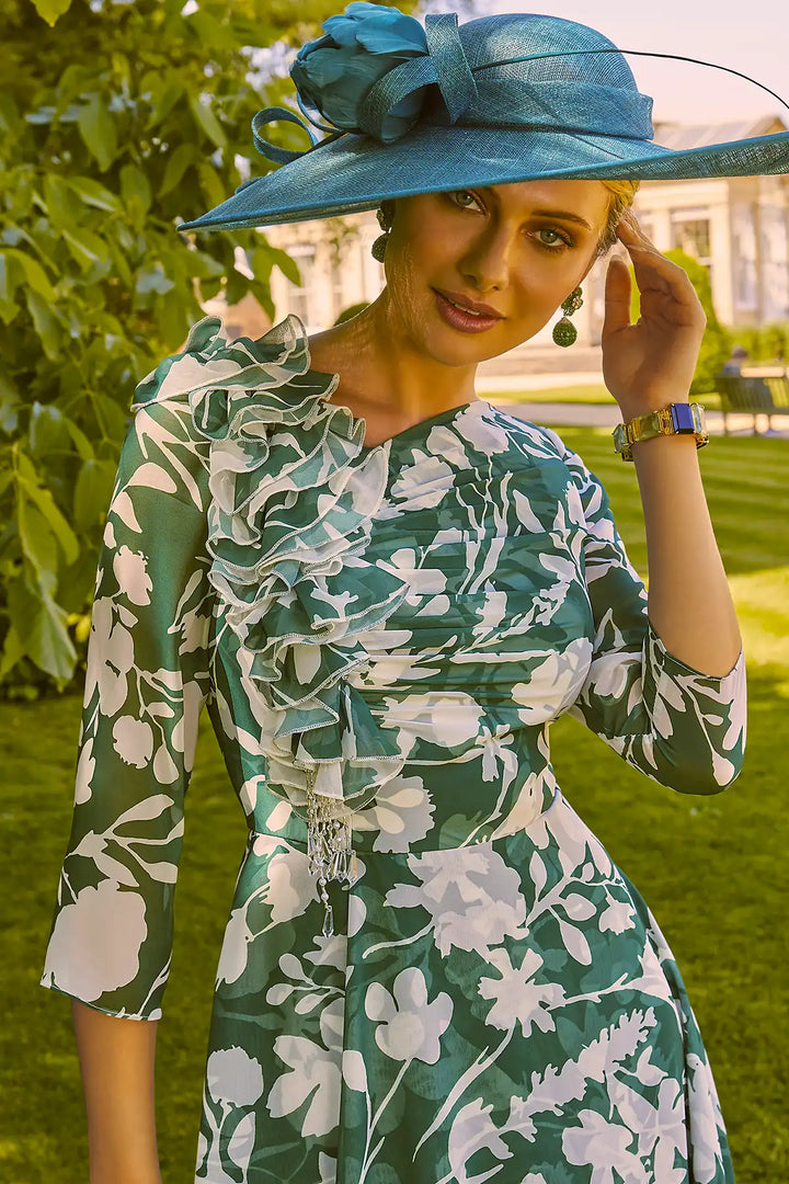 Close-up of an elegant woman in Invitations by Veni 36021A shamrock green dress with ivory floral design and high-low skirt