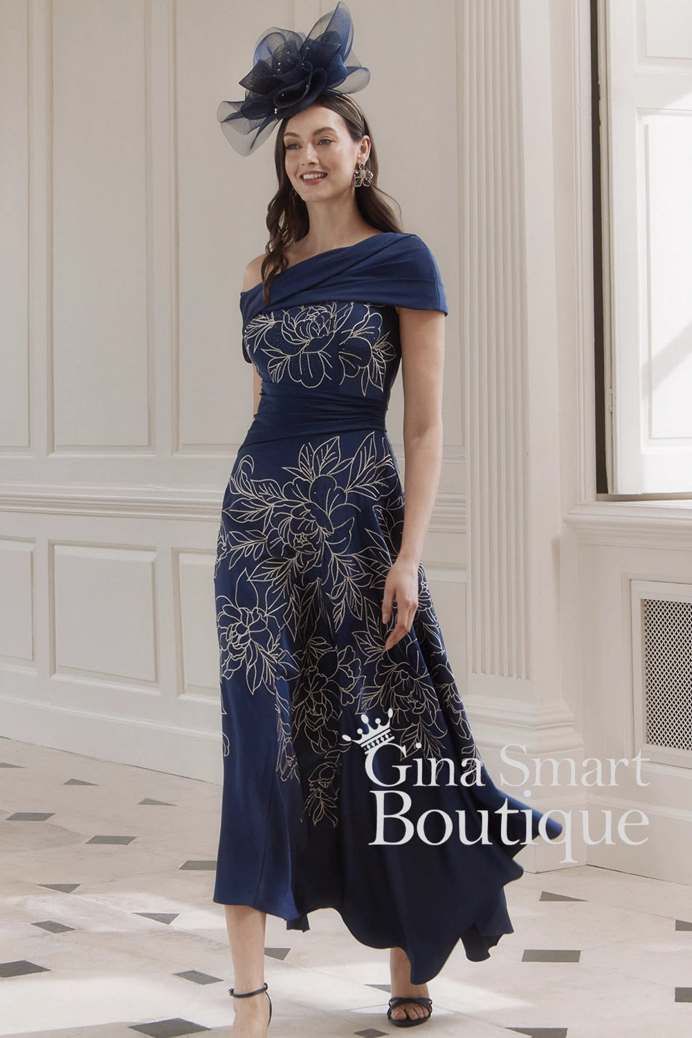 John Charles navy blue asymmetric dress with delicate oyster floral embroidery and one-shoulder drape – elegant Mother of the Bride outfit.