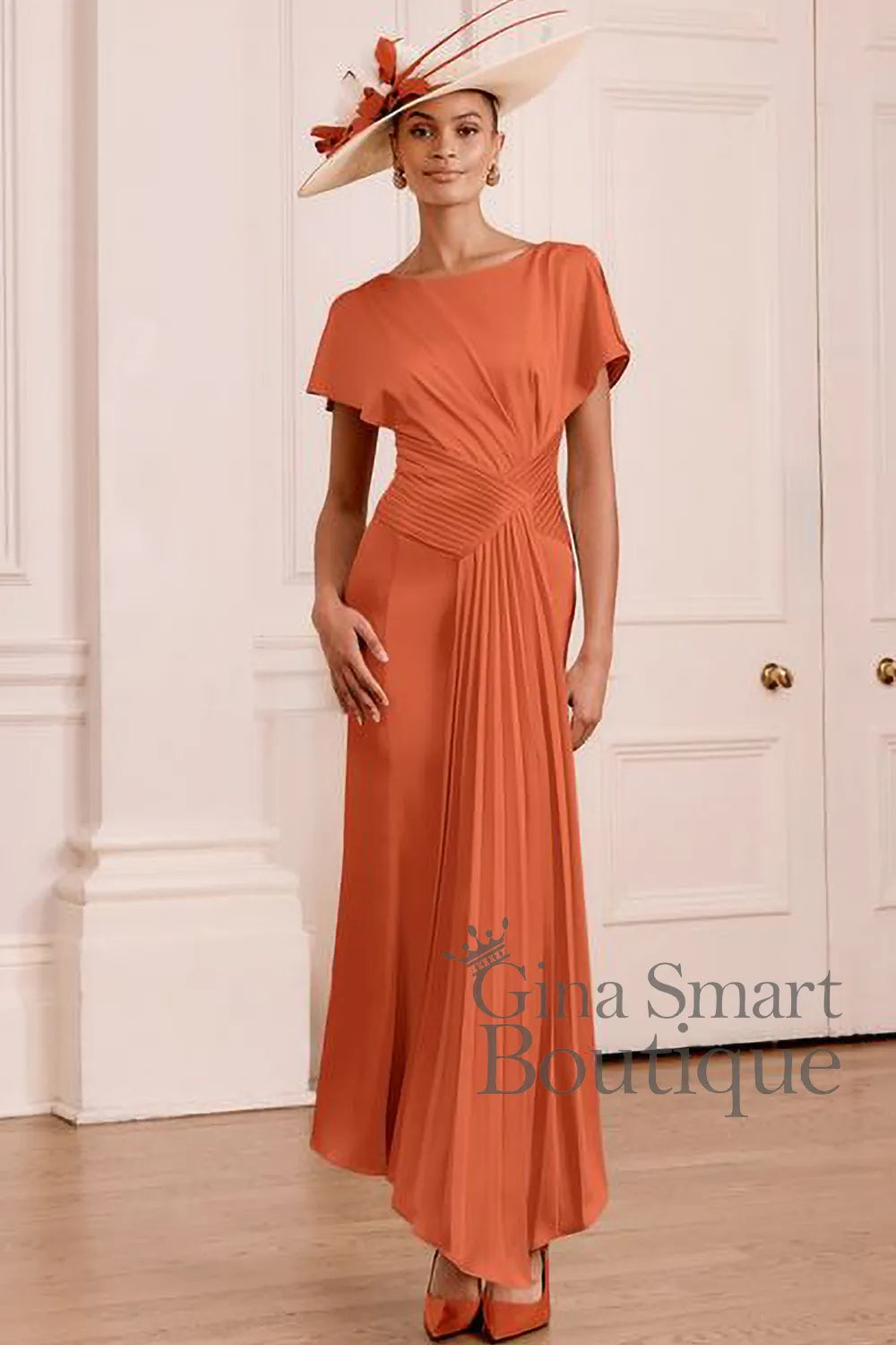 John Charles 66783 Terracotta maxi dress featuring fine all over pleating, cape effect flutter sleeves and a draped criss-cross waistband - available at Gina Smart Boutique.