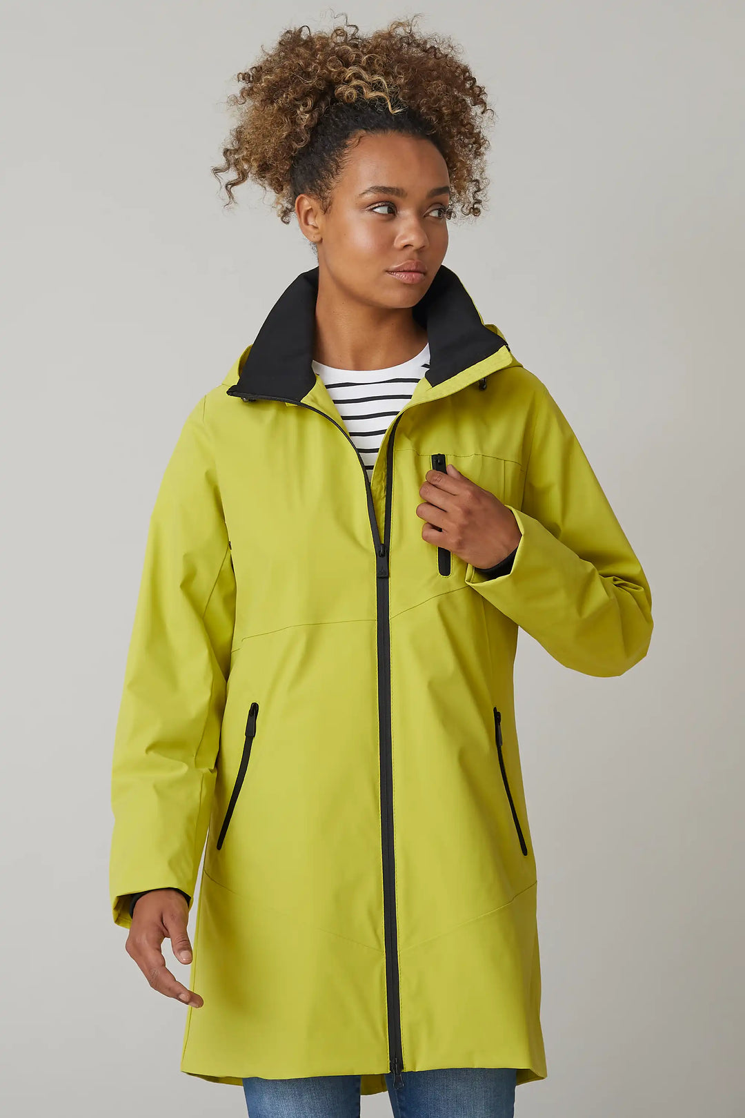 A model showcases a bright chartreuse raincoat with a protective hood, zip front, and spacious pockets for a rainy spring day, style 0124-2493-88-41