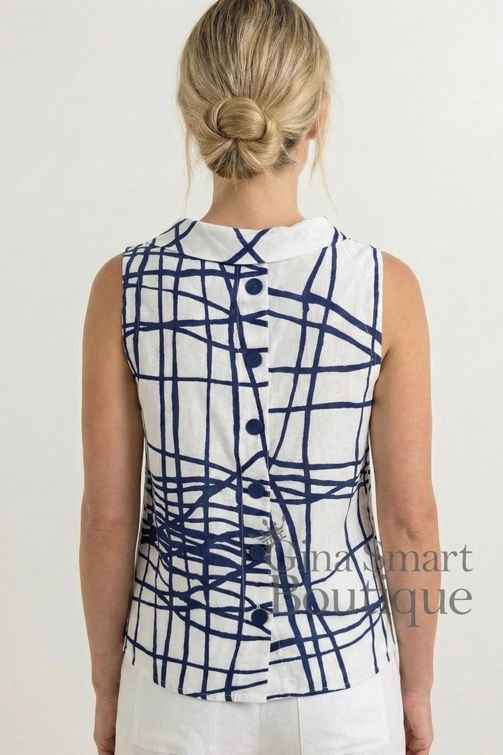 Woman wearing a sleeveless top with blue abstract pattern on a white background