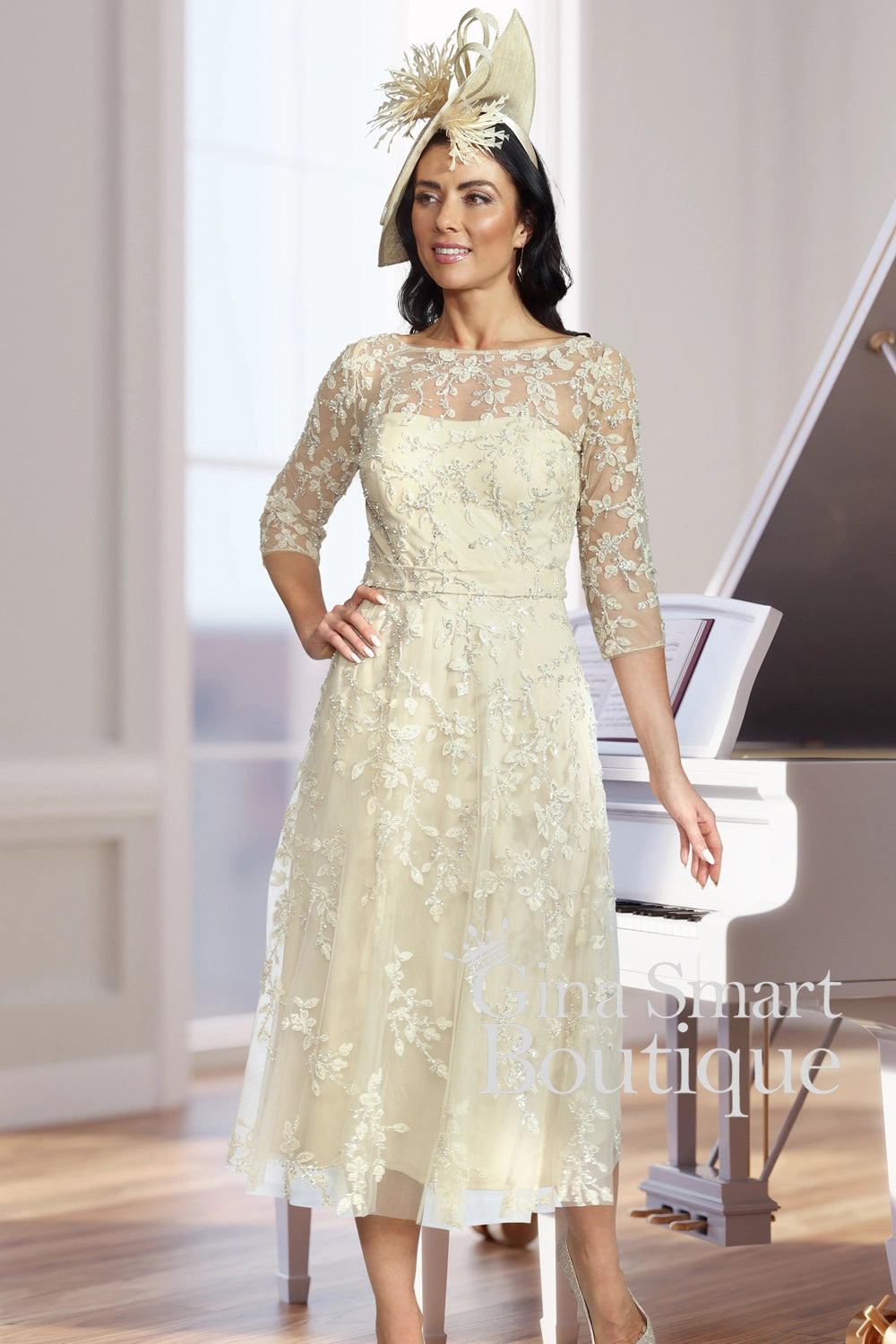 Woman in a lace dress standing in front of a piano, with 'Smart Boutique' branding.